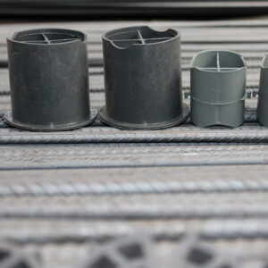 Grey plastic chair spacers in two heights on reinforcing bars