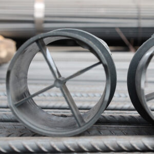 Round grey plastic spacers on reinforcing bars