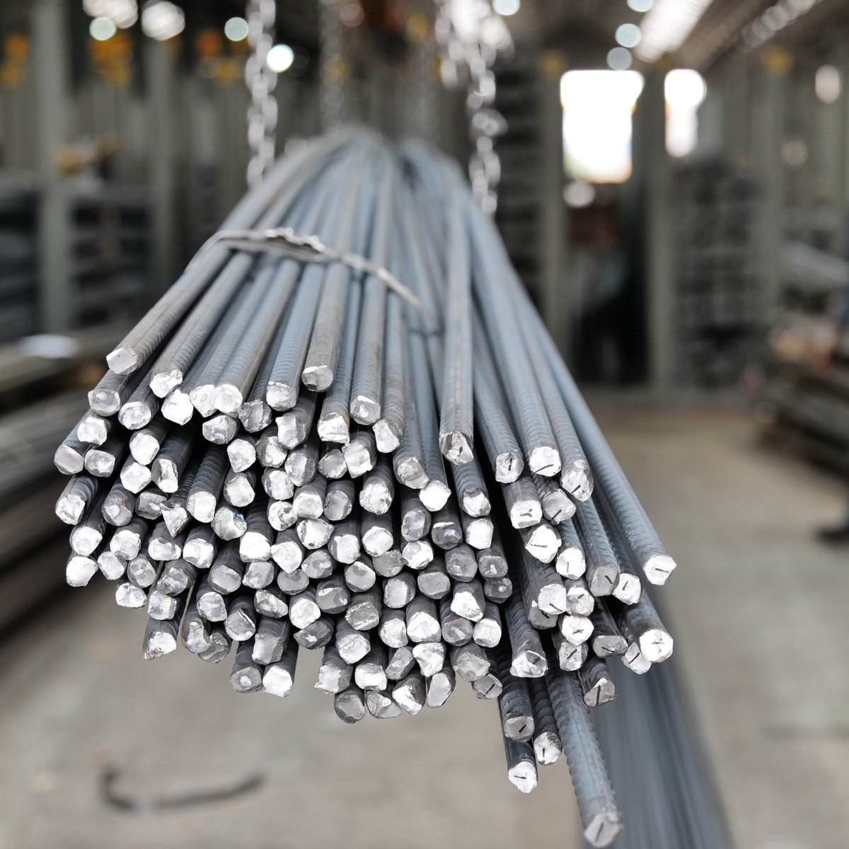 Bundle of Y bar reinforcing steel lengths, strapped and lifted, with the cut ends facing the camera