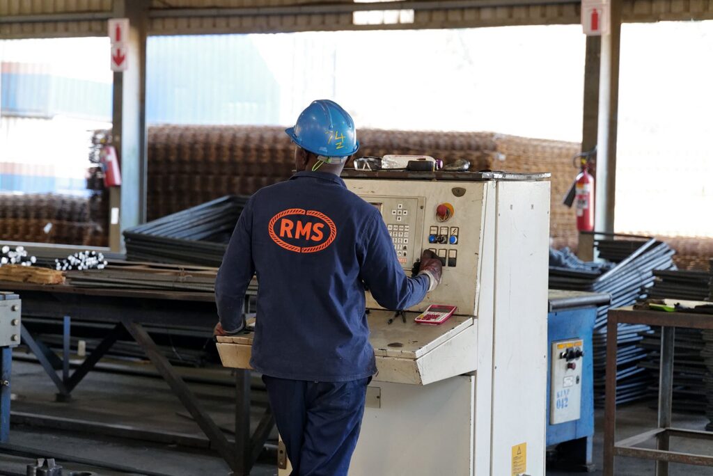 Welded Mesh and Cut and Bend for Coastal Builds in Durban and Richards Bay 3 RMS Durban machine operator at the control panel of a reinforcing steel processing line