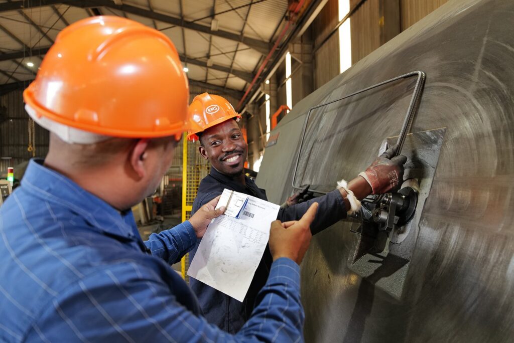 Welded Mesh and Cut and Bend for Coastal Builds in Durban and Richards Bay 4 RMS Durban team checking a bending schedule while bending reinforcing steel