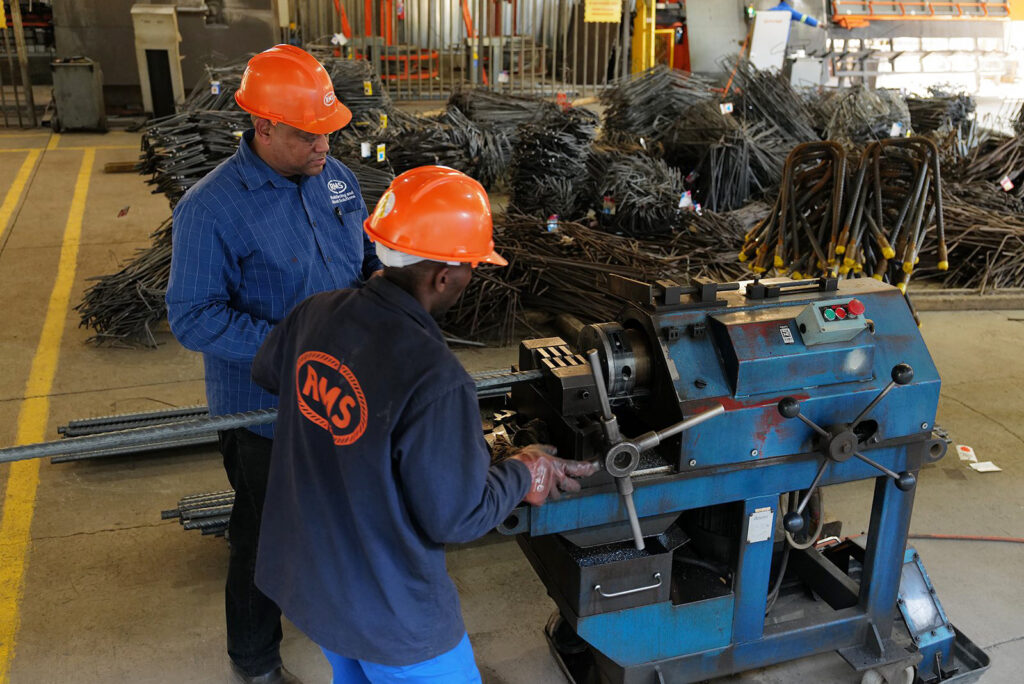 Welded Mesh and Cut and Bend for Coastal Builds in Durban and Richards Bay 7 RMS Durban team at a reinforcing steel processing machine
