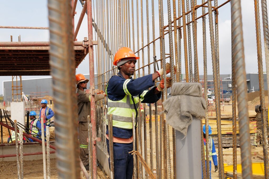 Welded Mesh and Cut and Bend for Coastal Builds in Durban and Richards Bay 14 Steel fixer tying a reinforced column cage on a KwaZulu-Natal construction site