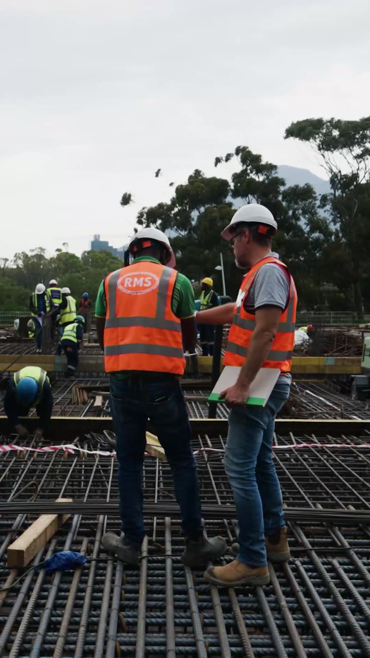 The Granger Building, Cape Town 7 RMS steel fixers in branded orange vests checking the reinforcement mat at The Granger Building, Cape Town
